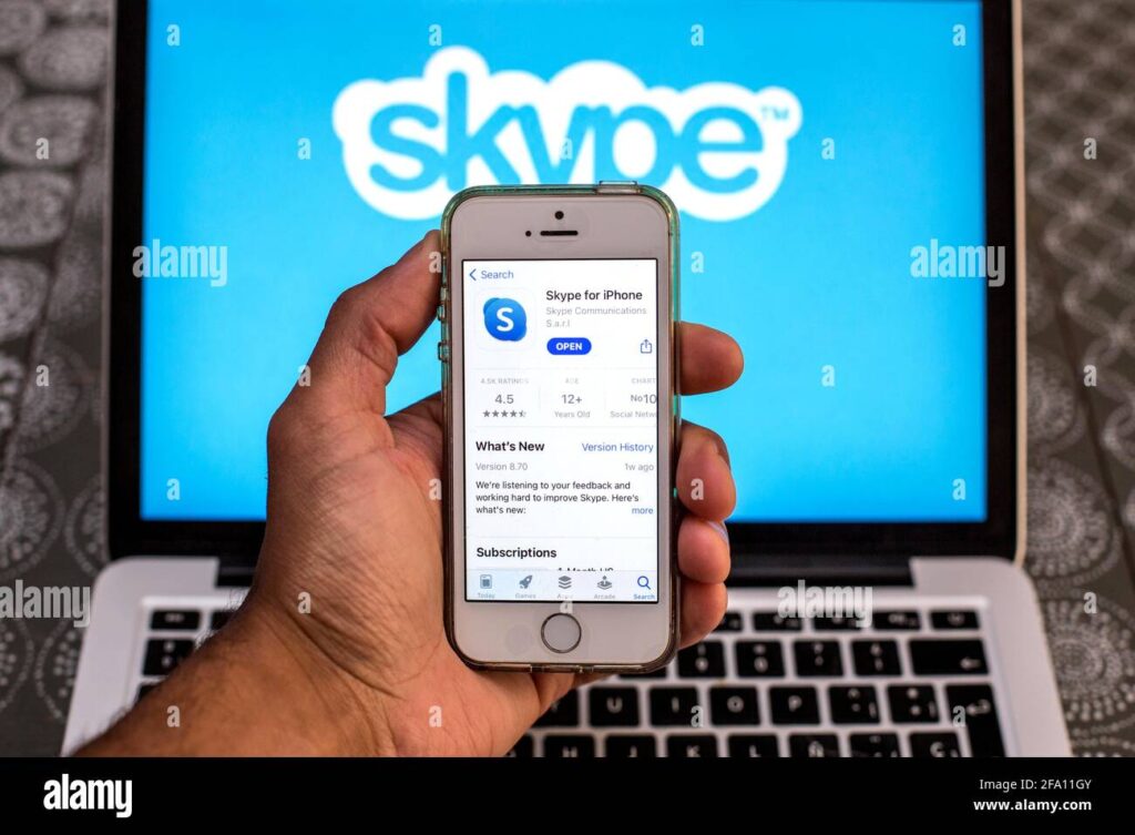 in this photo illustration a skype app in app store seen displayed on a smartphone screen with a skype logo displayed on a laptop in the background 2FA11GY